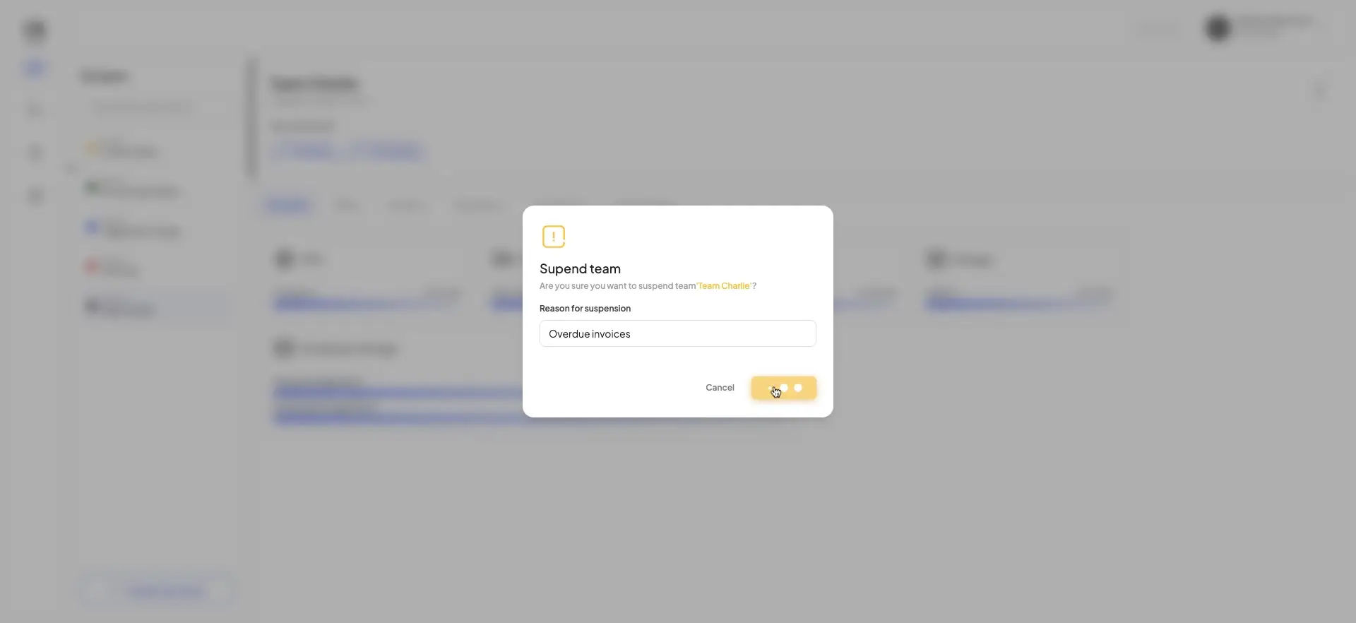 The screenshot shows a modal window asking the user to confirm the suspension of the team "Team Charlie". The reason for suspension is "Overdue invoices".